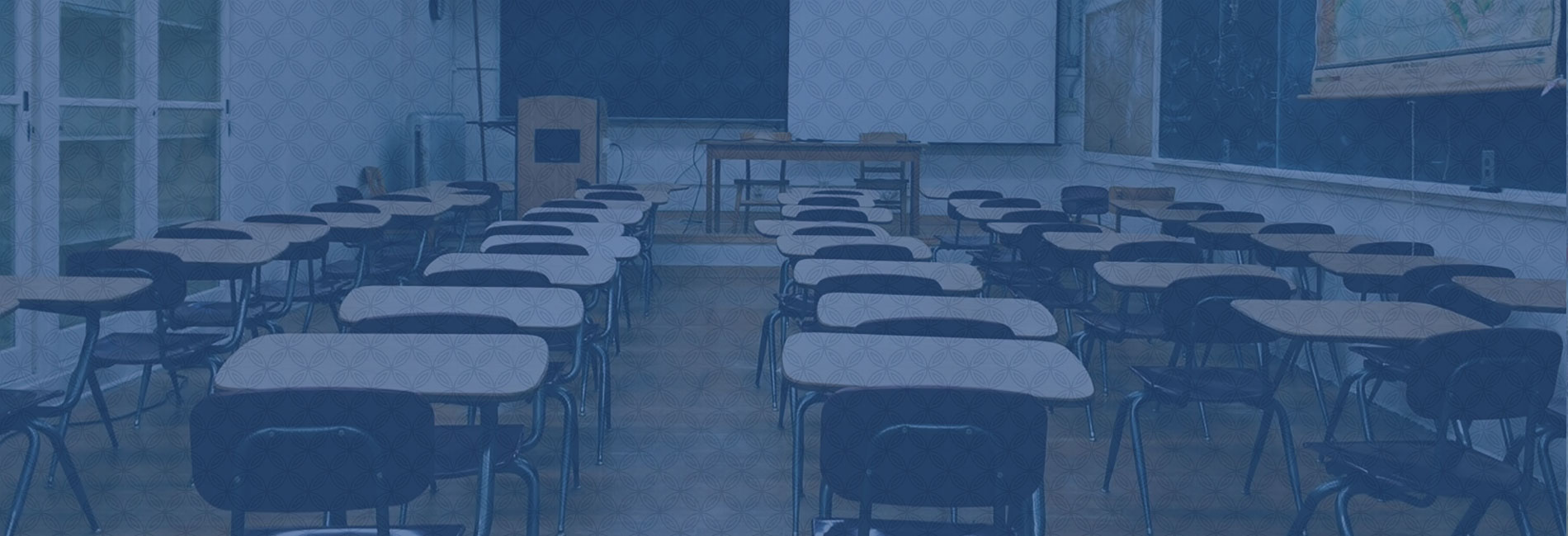 Banner image: empty classroom with desks, blackboard, projector screen